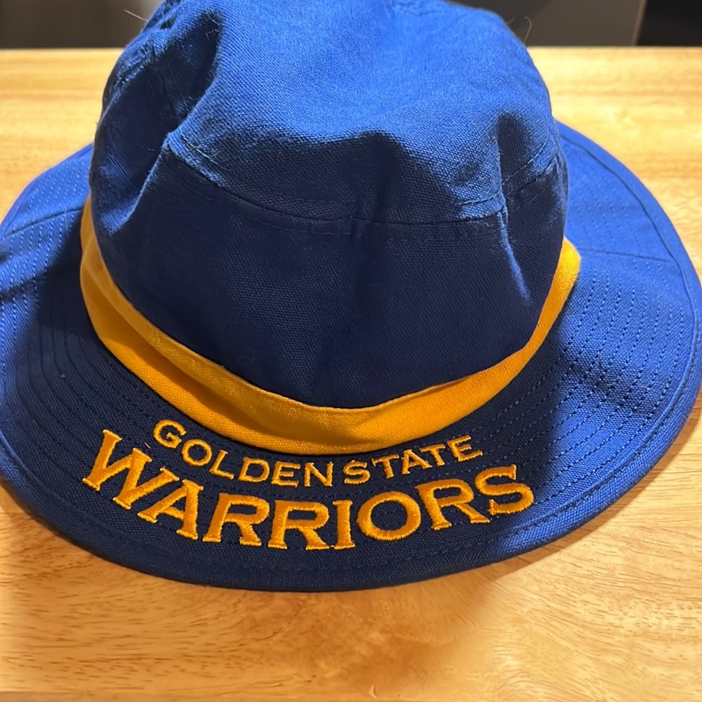 Blue and gold Golden State Warrior bucket hat size L/XL, never worn.